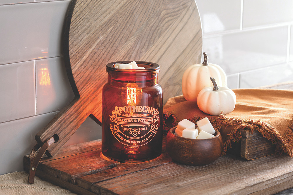 The Apothecary Illumination Fragrance warmer will allure you with amber-colored glass and an Edison style bulb from within. The enchanting dark academia glow that fills the room will set the vibe for a relaxing night at home while bringing any style of decor to life. Melt your favorite home fragrance in the dish on top of the vessel, which resembles an old fashioned medicine jar.