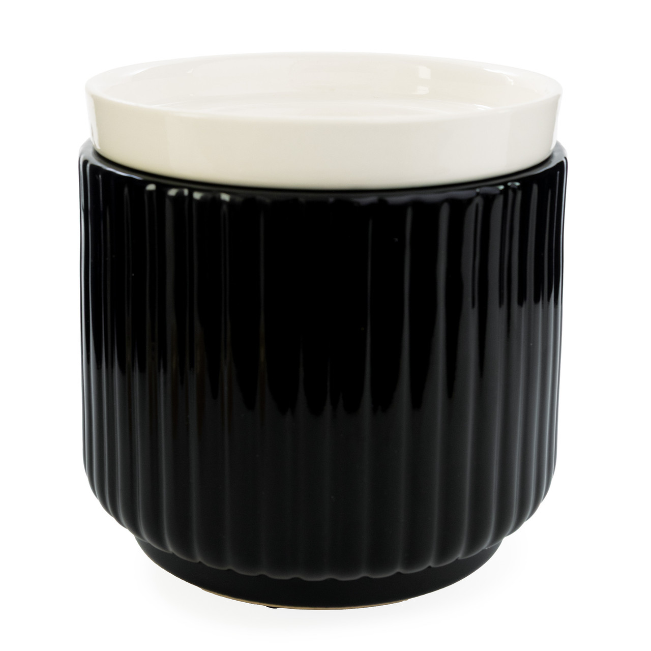 Glossy black ribbed ceramic meets a crisp white removable dish in the Noir Wax Warmer for a striking, modern silhouette that elevates contemporary decor.